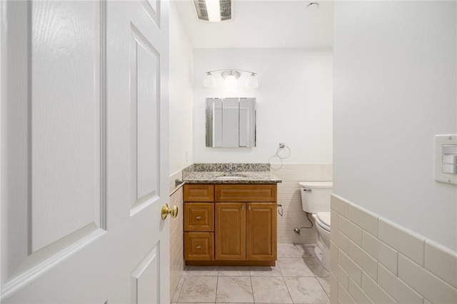 752 Quaker Ln Unit C311, Warwick, RI 02818 - half bathroom with tile walls, vanity, a wainscoted wall, and tile patterned floors
