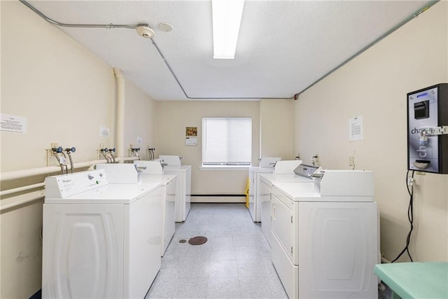 752 Quaker Ln Unit C311, Warwick, RI 02818 - community laundry room featuring washer and clothes dryer, baseboard heating, and light flooring