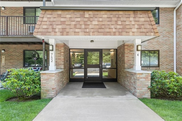 752 Quaker Ln Unit C311, Warwick, RI 02818 - doorway to property with brick siding and a balcony