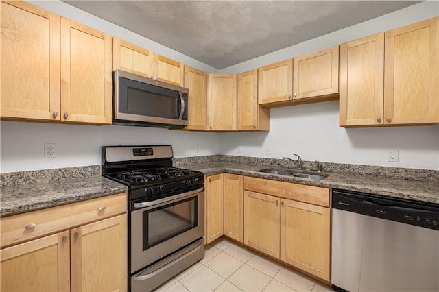 752 Quaker Ln Unit C311, Warwick, RI 02818 - kitchen with appliances with stainless steel finishes, light brown cabinets, light tile patterned floors, and dark stone countertops