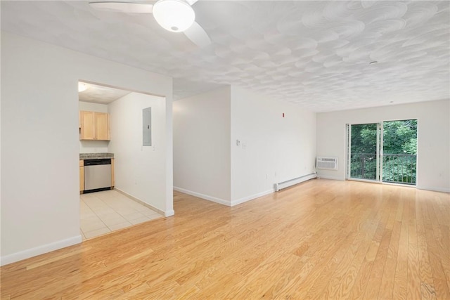 752 Quaker Ln Unit C311, Warwick, RI 02818 - empty room featuring a wall mounted AC, light wood-style flooring, electric panel, ceiling fan, and a baseboard heating unit