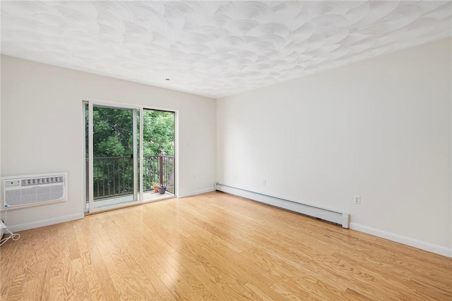 752 Quaker Ln Unit C311, Warwick, RI 02818 - unfurnished room with baseboard heating, wood finished floors, and a wall mounted AC