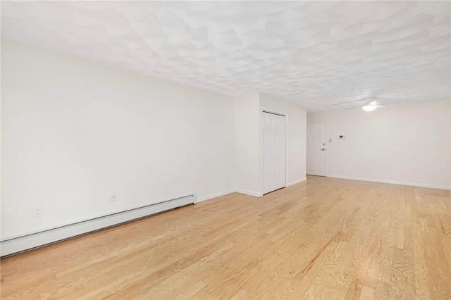 752 Quaker Ln Unit C311, Warwick, RI 02818 - empty room with a baseboard radiator and light wood-type flooring