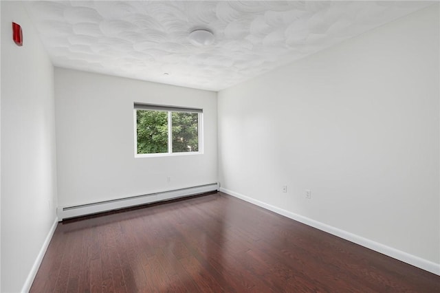 752 Quaker Ln Unit C311, Warwick, RI 02818 - empty room featuring a baseboard heating unit and wood finished floors