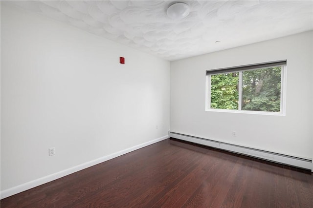 752 Quaker Ln Unit C311, Warwick, RI 02818 - empty room featuring a baseboard heating unit and wood finished floors