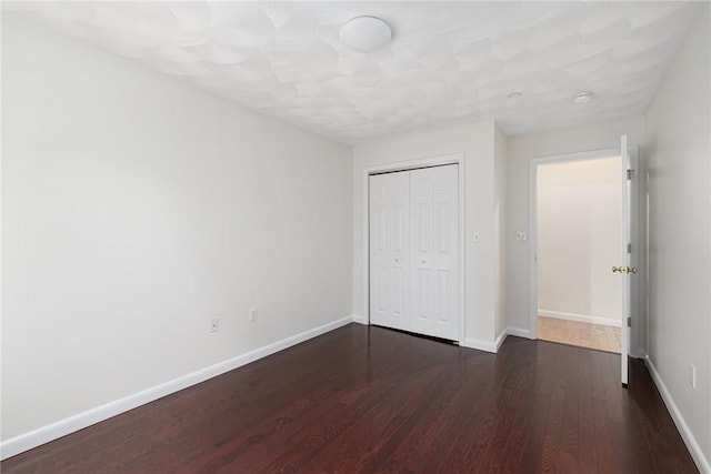 752 Quaker Ln Unit C311, Warwick, RI 02818 - unfurnished bedroom with dark wood-style floors and a closet