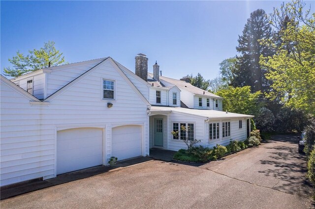 2 Cherry Ln, Bristol, RI 02809 - traditional home featuring a chimney, driveway, and a garage