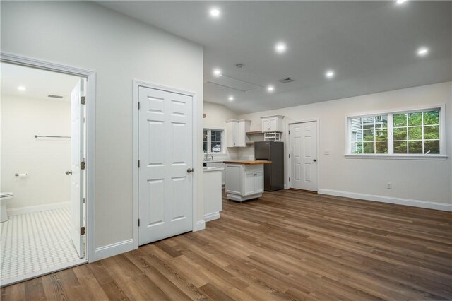2 Cherry Ln, Bristol, RI 02809 - unfurnished living room with wood finished floors, baseboards, lofted ceiling, and recessed lighting