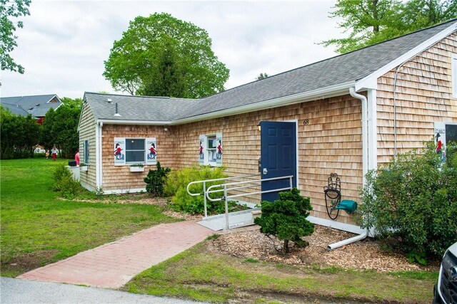 2 Cherry Ln, Bristol, RI 02809 - view of front of house with a front yard and a shingled roof