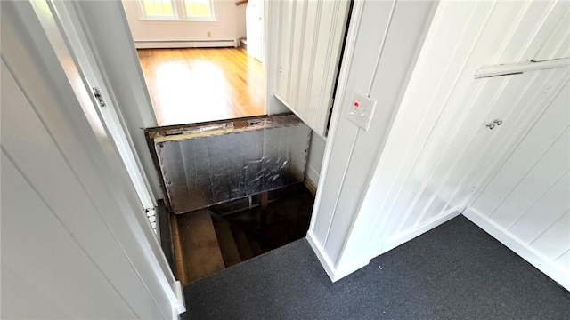 52 Pleasant View Rd, Warwick, RI 02888 - corridor with a baseboard heating unit and wood finished floors