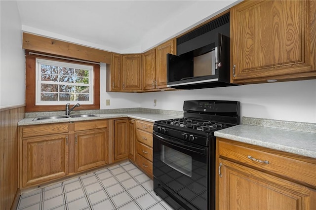 52 Pleasant View Rd, Warwick, RI 02888 - kitchen featuring black appliances, brown cabinetry, a sink, and light countertops