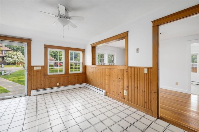 52 Pleasant View Rd, Warwick, RI 02888 - spare room featuring a wainscoted wall, wood walls, ceiling fan, baseboard heating, and light flooring