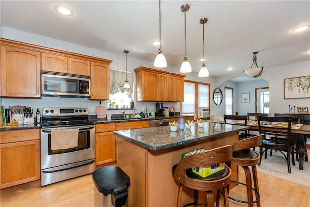 2 Ann St, North Providence, RI 02904 - kitchen featuring appliances with stainless steel finishes, a kitchen island, a sink, light wood-type flooring, and recessed lighting