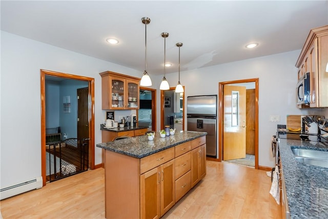 2 Ann St, North Providence, RI 02904 - kitchen featuring stainless steel appliances, a baseboard radiator, light wood-style floors, glass insert cabinets, and hanging light fixtures