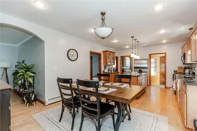 2 Ann St, North Providence, RI 02904 - dining room with arched walkways, light wood-type flooring, recessed lighting, ornamental molding, and baseboards