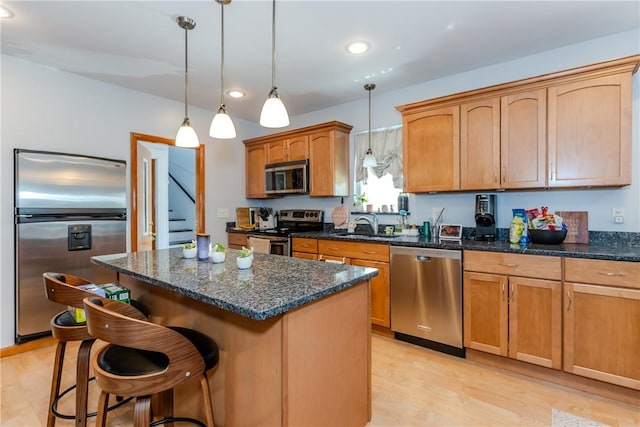 2 Ann St, North Providence, RI 02904 - kitchen with appliances with stainless steel finishes, recessed lighting, a kitchen island, light wood-style flooring, and a kitchen bar