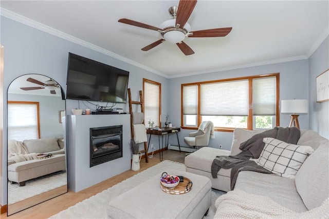 2 Ann St, North Providence, RI 02904 - living area with a glass covered fireplace, a ceiling fan, baseboard heating, wood finished floors, and ornamental molding