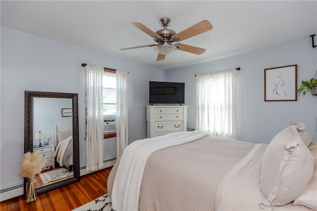 2 Ann St, North Providence, RI 02904 - bedroom with multiple windows, dark wood finished floors, baseboard heating, and a ceiling fan