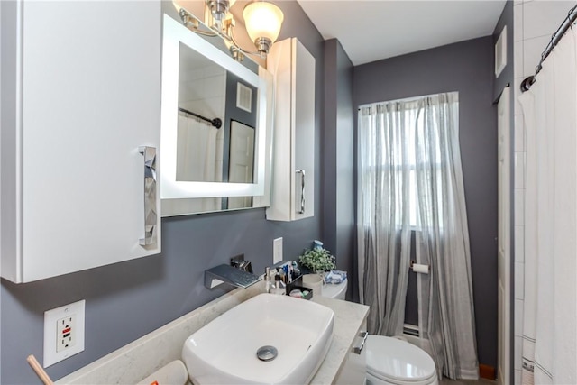 2 Ann St, North Providence, RI 02904 - bathroom with toilet, vanity, a chandelier, and a shower with shower curtain