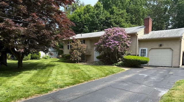 20 Maplewood Dr, Coventry, RI 02816 - view of front of house with an attached garage, a chimney, a front yard, and asphalt driveway
