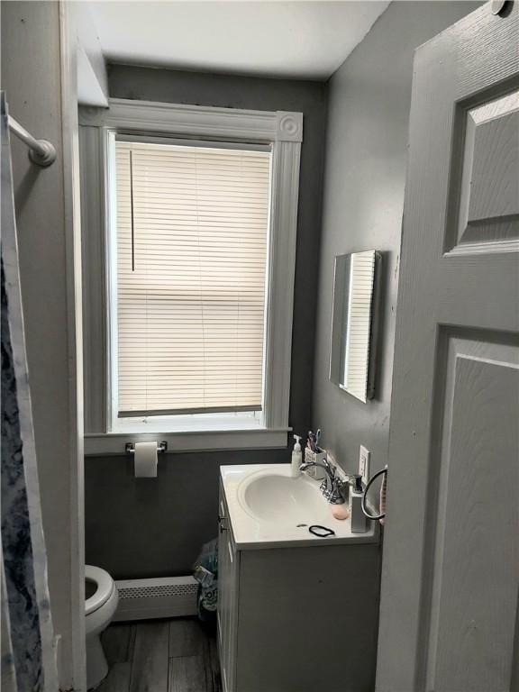5 Peter St, Providence, RI 02904 - bathroom with toilet, vanity, baseboard heating, and wood finished floors