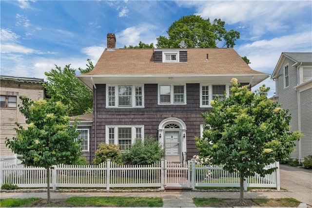 112 Elton St, Providence, RI 02906 - colonial home featuring a chimney, a fenced front yard, and roof with shingles