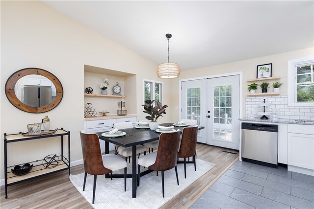 259 Buttonwoods Ave, Warwick, RI 02886 - dining space featuring healthy amount of natural light, light wood-style floors, french doors, and vaulted ceiling