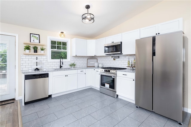 259 Buttonwoods Ave, Warwick, RI 02886 - kitchen with stainless steel appliances, a sink, tasteful backsplash, light stone countertops, and lofted ceiling