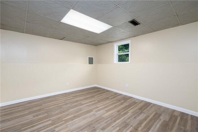 259 Buttonwoods Ave, Warwick, RI 02886 - empty room featuring wood finished floors, baseboards, and a paneled ceiling