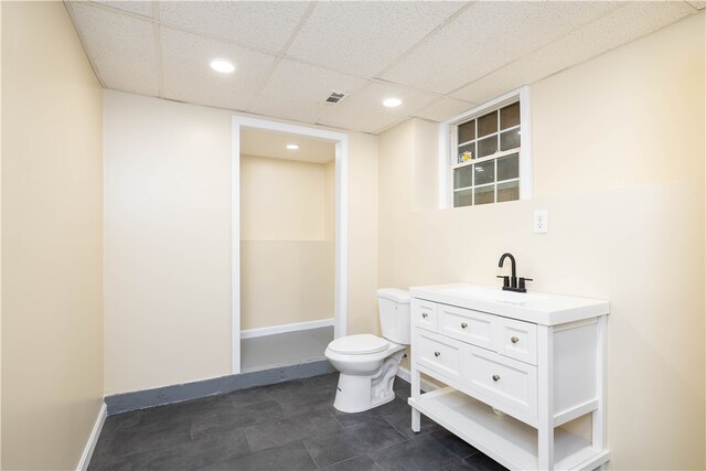 259 Buttonwoods Ave, Warwick, RI 02886 - bathroom featuring toilet, vanity, a drop ceiling, recessed lighting, and baseboards