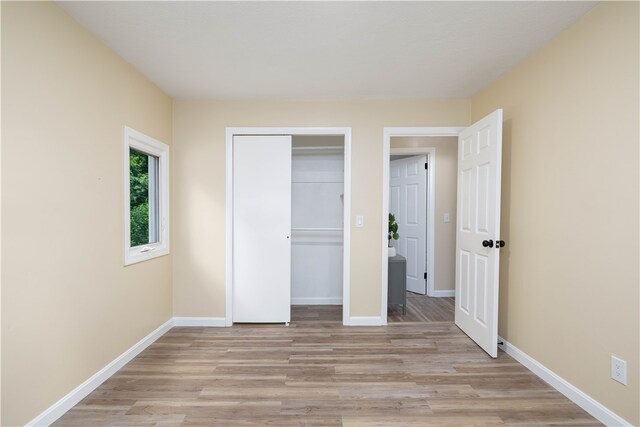 259 Buttonwoods Ave, Warwick, RI 02886 - unfurnished bedroom with light wood-style floors, baseboards, and a closet