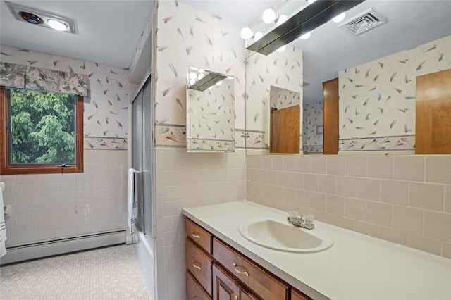 236 Indian Trl, Narragansett, RI 02874 - bathroom featuring a baseboard heating unit, tile walls, wallpapered walls, vanity, and enclosed tub / shower combo