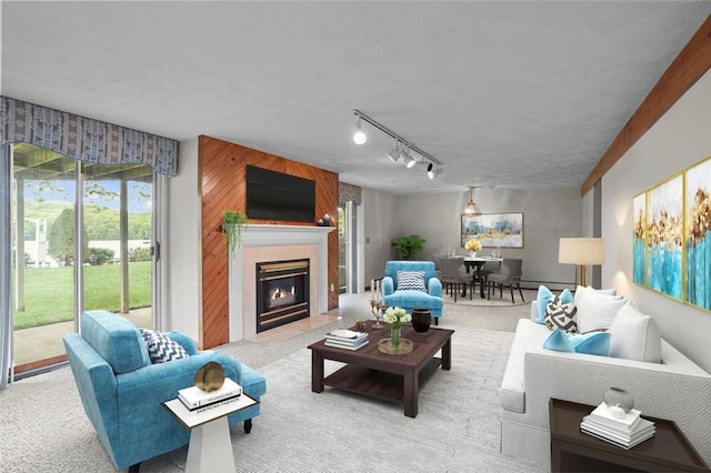236 Indian Trl, Narragansett, RI 02874 - carpeted living room with a fireplace with flush hearth, plenty of natural light, a baseboard heating unit, and track lighting