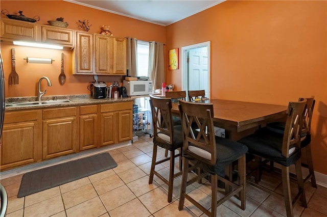 263 Front St, Lincoln, RI 02865 - kitchen featuring white microwave, a sink, light tile patterned flooring, and ornamental molding