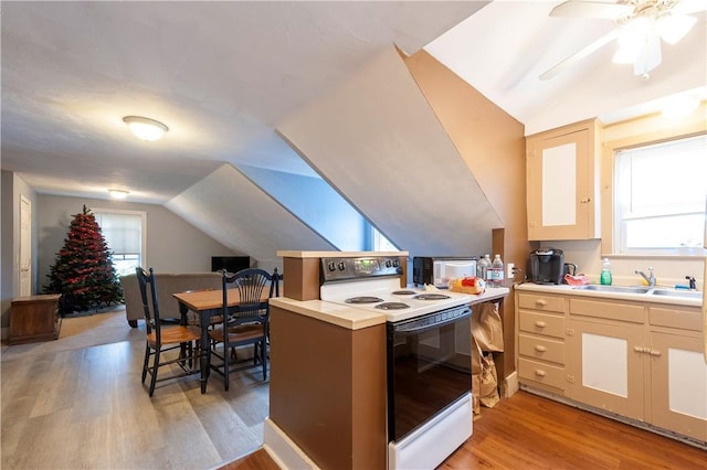 263 Front St, Lincoln, RI 02865 - kitchen with electric stove, a sink, vaulted ceiling, light wood-style flooring, and plenty of natural light