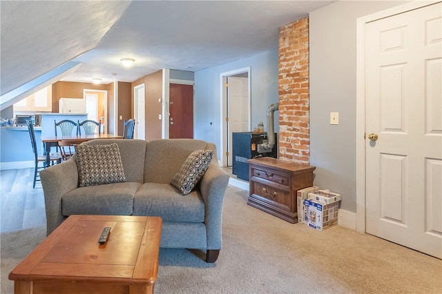 263 Front St, Lincoln, RI 02865 - living room featuring carpet floors, a wood stove, and baseboards