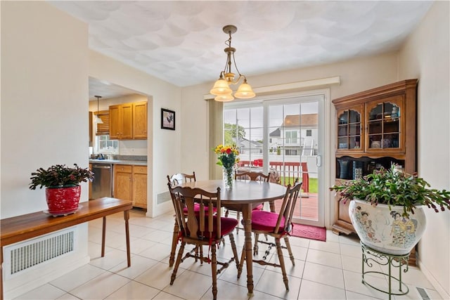 53 Hyde Ave, Pawtucket, RI 02861 - dining area featuring light tile patterned floors, a chandelier, and baseboards