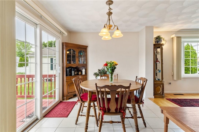 53 Hyde Ave, Pawtucket, RI 02861 - dining area with a chandelier, light tile patterned flooring, and baseboards