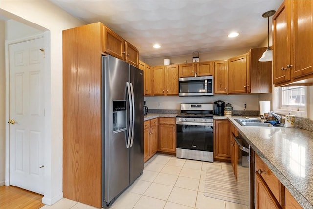 53 Hyde Ave, Pawtucket, RI 02861 - kitchen featuring stainless steel appliances, brown cabinetry, a sink, recessed lighting, and hanging light fixtures