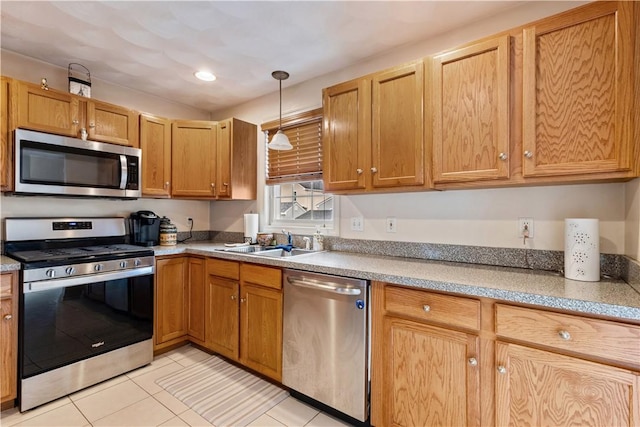 53 Hyde Ave, Pawtucket, RI 02861 - kitchen featuring appliances with stainless steel finishes, light tile patterned floors, light countertops, hanging light fixtures, and a sink