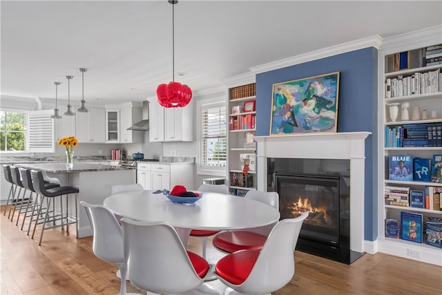 40 Kettle Point Ave, East Providence, RI 02914 - dining space with wood finished floors, a glass covered fireplace, and crown molding