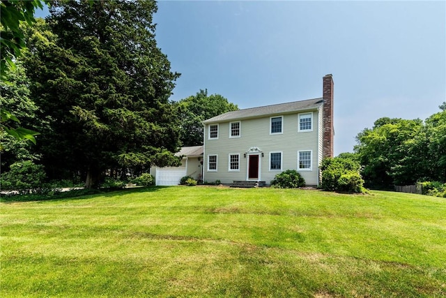 59 Intrepid Ln, Jamestown, RI 02835 - view of front of home featuring a chimney, a front yard, and a garage