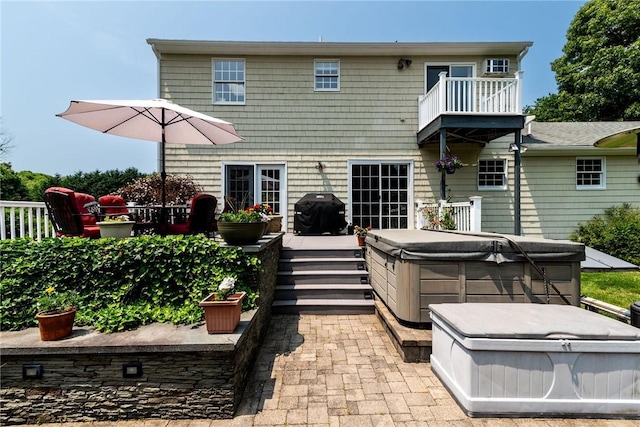 59 Intrepid Ln, Jamestown, RI 02835 - back of house featuring a hot tub, a balcony, and a patio