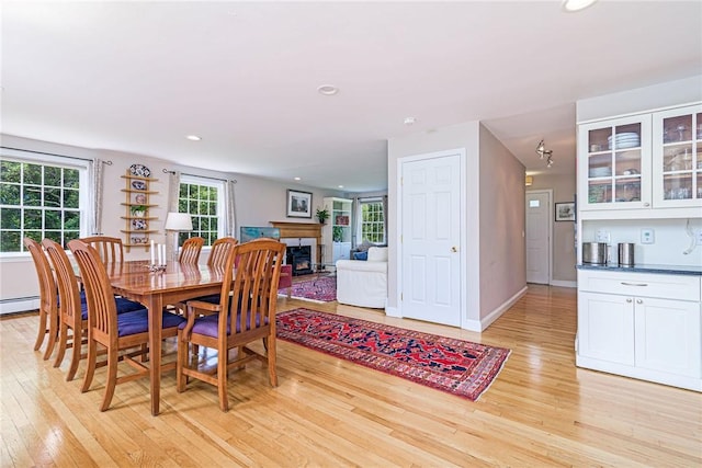 59 Intrepid Ln, Jamestown, RI 02835 - dining room with light wood-style flooring, recessed lighting, a fireplace, and baseboards