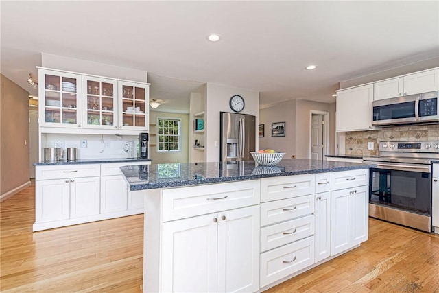 59 Intrepid Ln, Jamestown, RI 02835 - kitchen featuring appliances with stainless steel finishes, decorative backsplash, light wood-style floors, white cabinetry, and recessed lighting