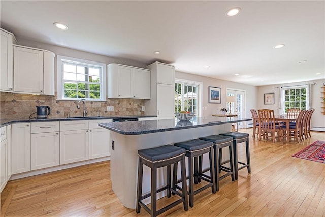 59 Intrepid Ln, Jamestown, RI 02835 - kitchen featuring a sink, a breakfast bar area, recessed lighting, light wood-type flooring, and a kitchen island