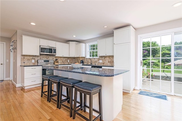 59 Intrepid Ln, Jamestown, RI 02835 - kitchen featuring stainless steel appliances, light wood-style floors, backsplash, and recessed lighting