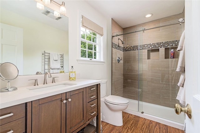 59 Intrepid Ln, Jamestown, RI 02835 - full bathroom featuring vanity, a stall shower, toilet, and wood finished floors