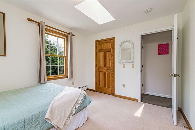 59 Intrepid Ln, Jamestown, RI 02835 - bedroom with a skylight, carpet floors, a baseboard heating unit, and baseboards