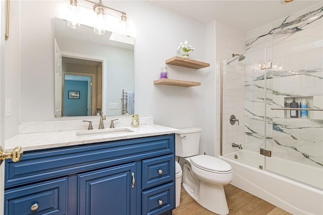 59 Intrepid Ln, Jamestown, RI 02835 - bathroom featuring toilet, bath / shower combo with glass door, vanity, and wood finished floors